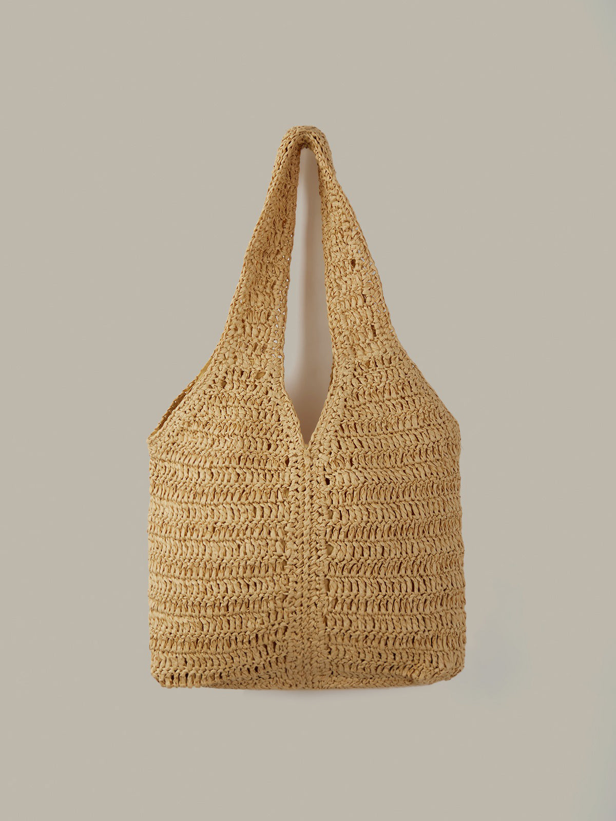 Woven beige handbag on a light gray background