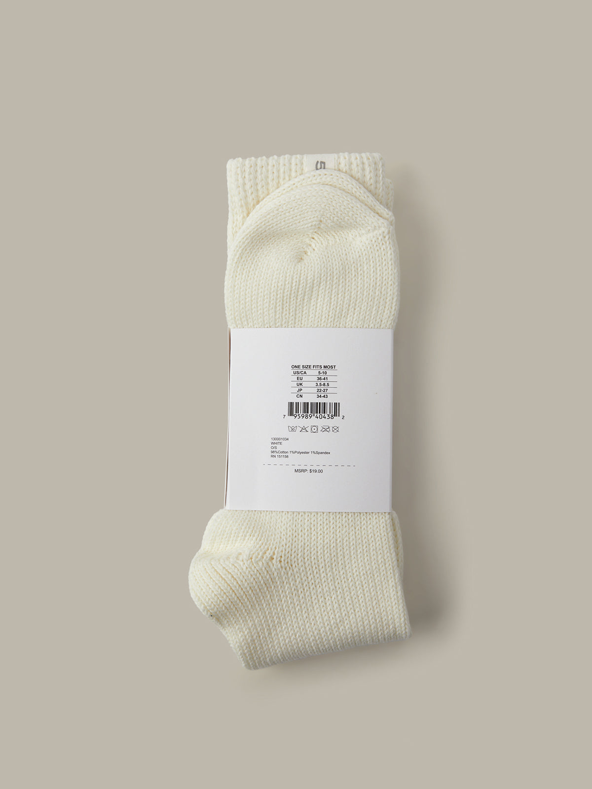 White sock with a label on a beige background