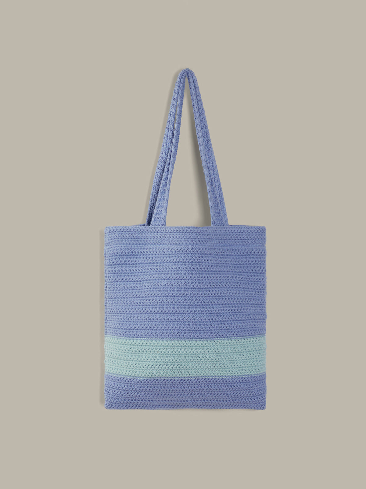 A light blue woven tote bag with two shoulder straps and a horizontal mint green stripe near the bottom, shown against a solid beige background.