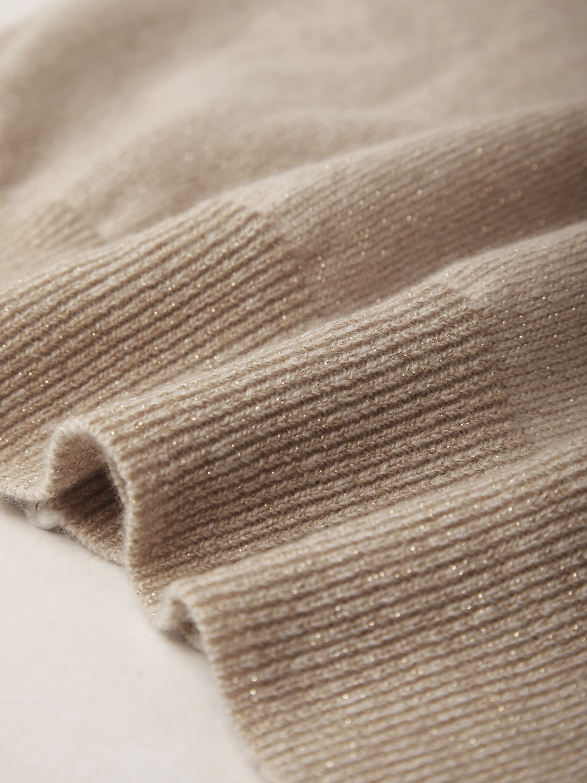 Close-up of beige knitted fabric texture