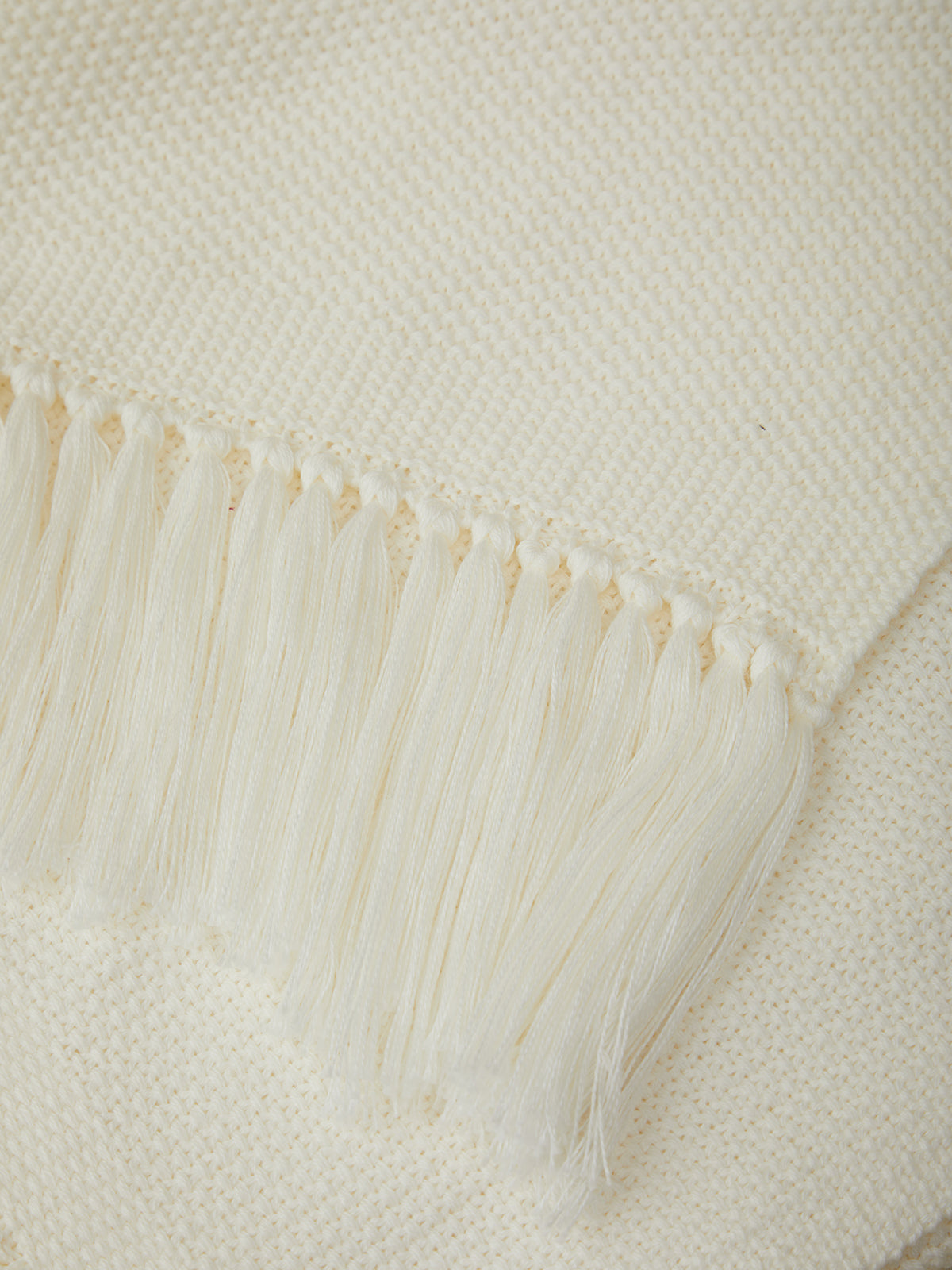 Close-up of a textured white fabric with frayed edges