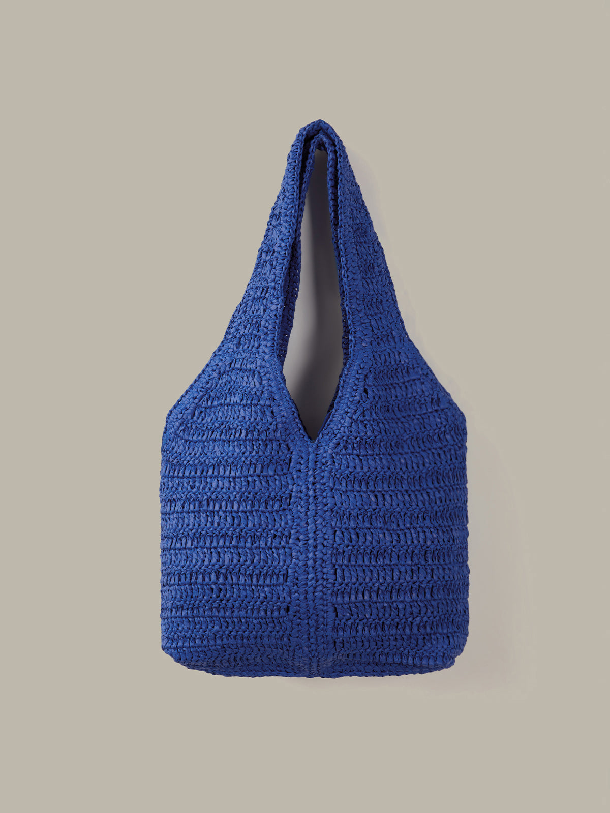 Blue textured handbag on a beige background
