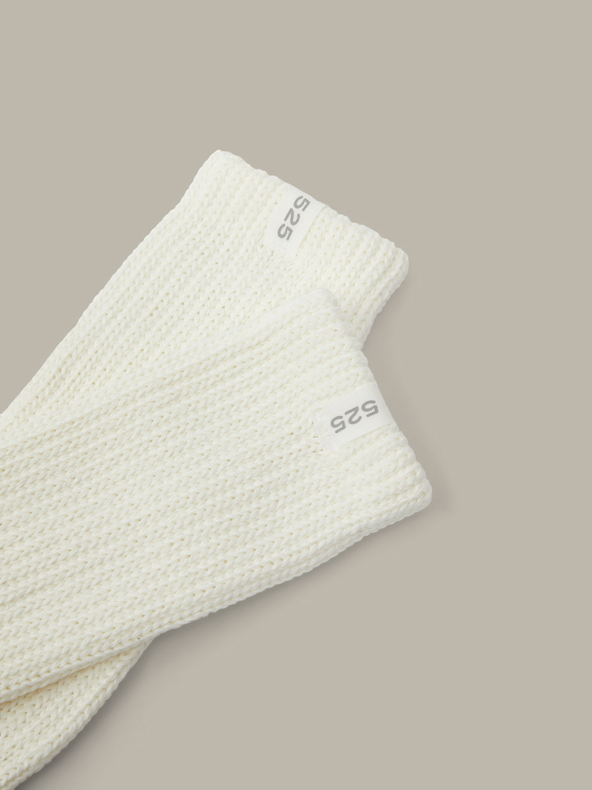 Light gray textured fabric with 'S25' branding on a beige background