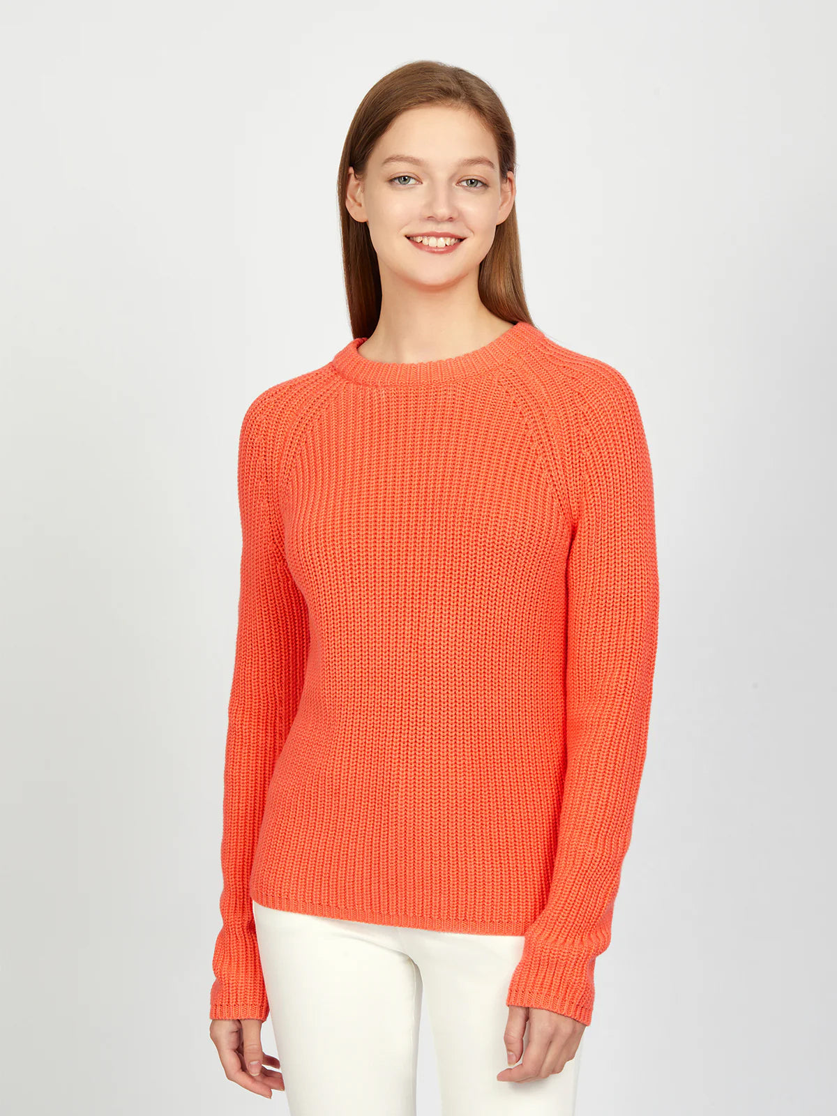 Woman wearing an orange sweater on a white background