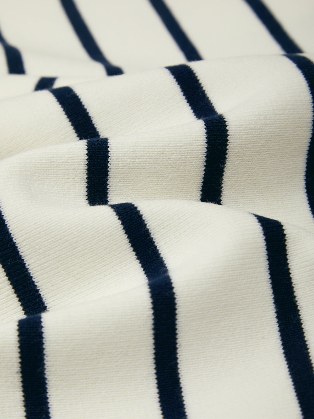 Close-up of a fabric with blue and white horizontal stripes.