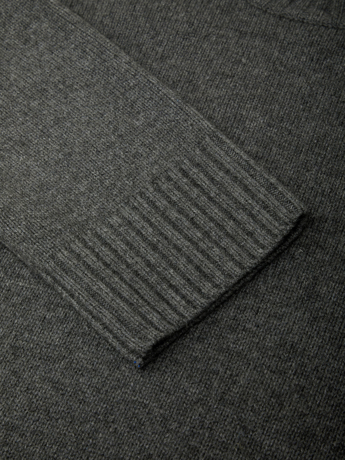 Close-up of dark gray fabric with a subtle pattern