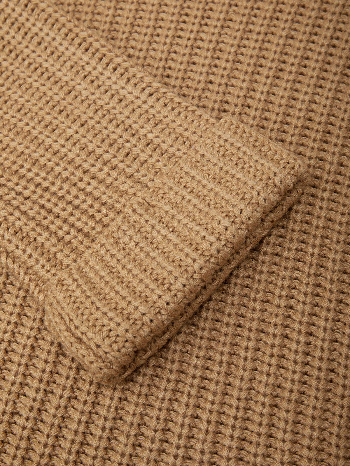 Close-up of beige woven fabric with a slight texture