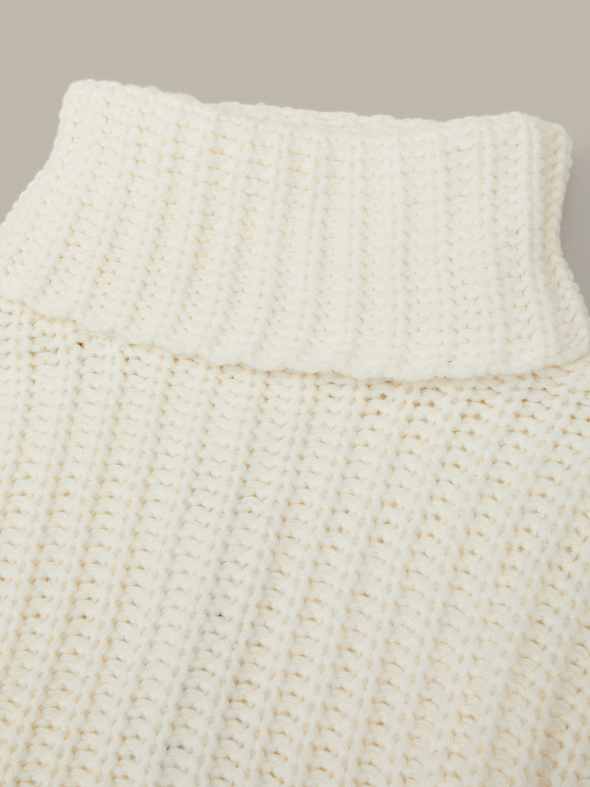 Close-up of a textured white fabric with a neutral background
