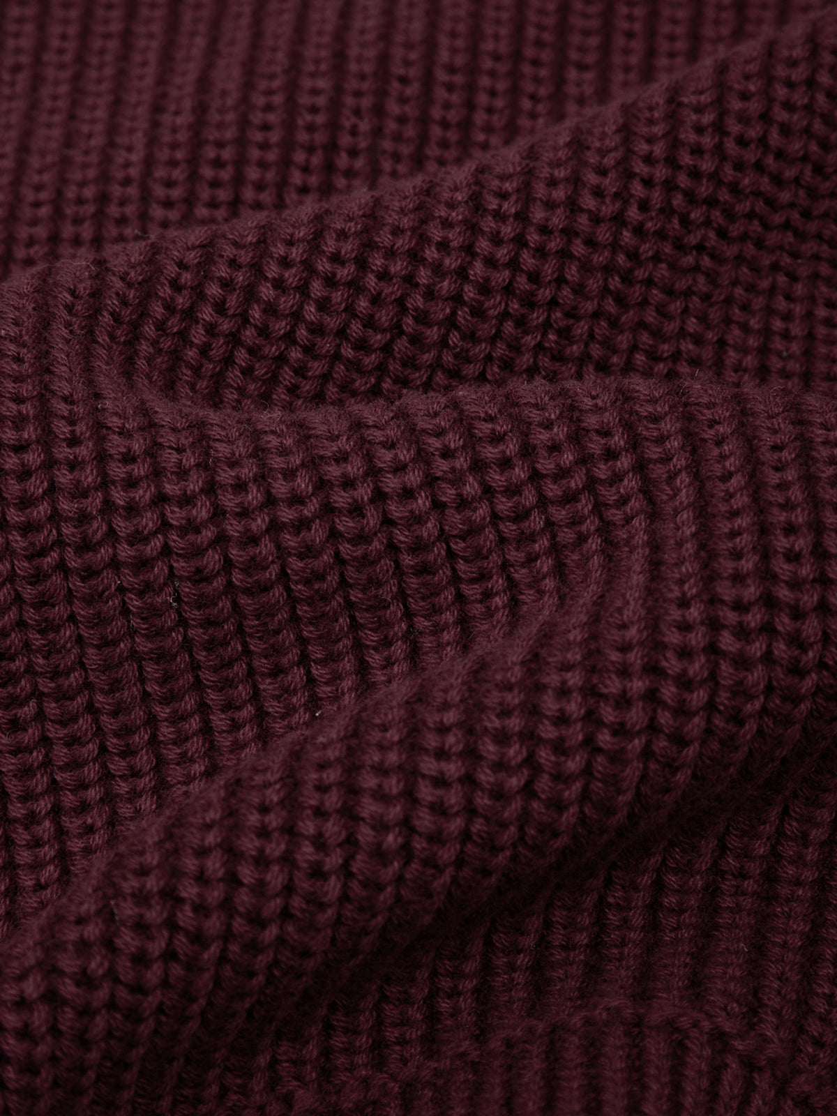Close-up of a textured burgundy fabric surface