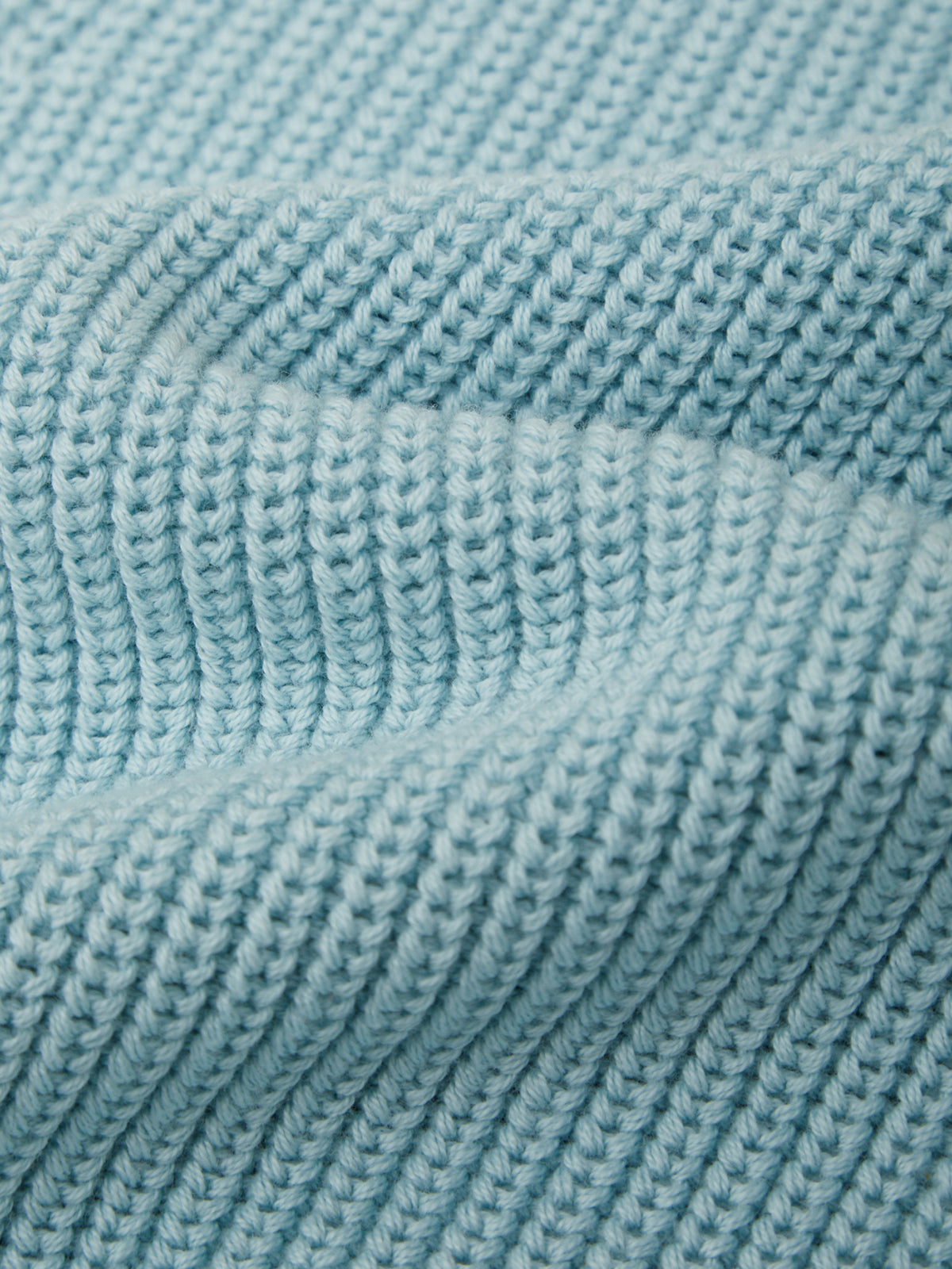 Close-up of a textured blue fabric with a ribbed pattern