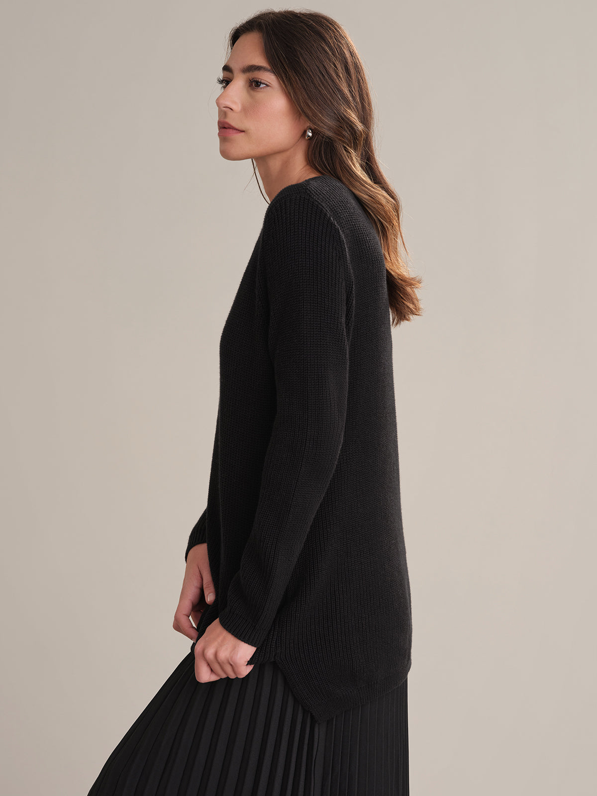 Woman wearing a black dress against a plain background