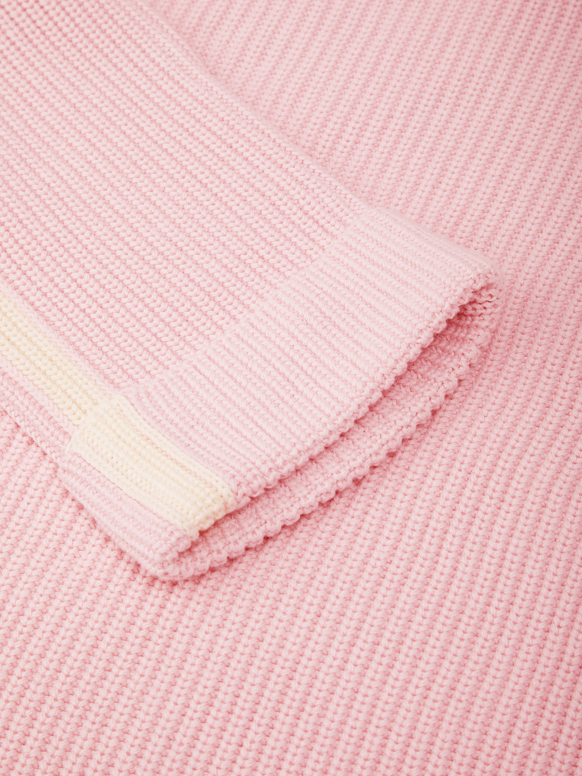 Close-up of a pink fabric with a white label