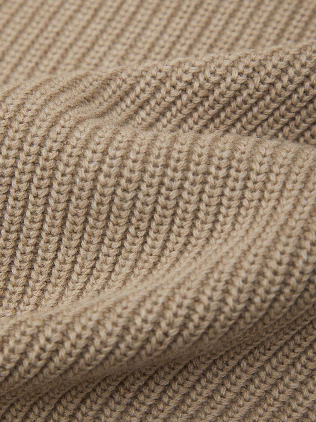 Close-up of beige knitted fabric texture