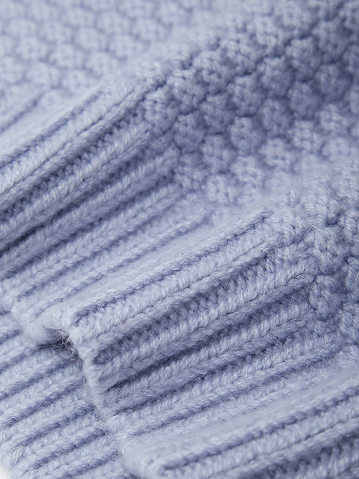 Close-up of a textured blue fabric with a ribbed pattern