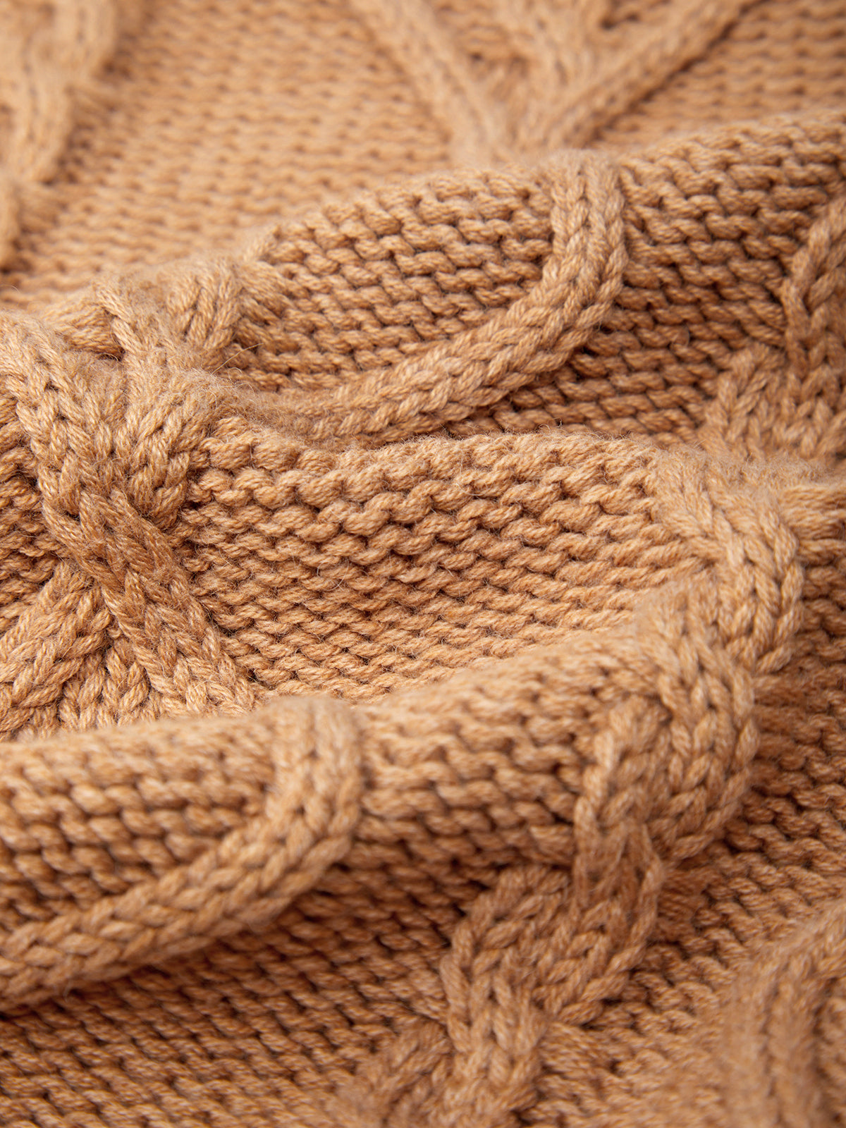 Close-up of a brown knitted fabric with cable pattern