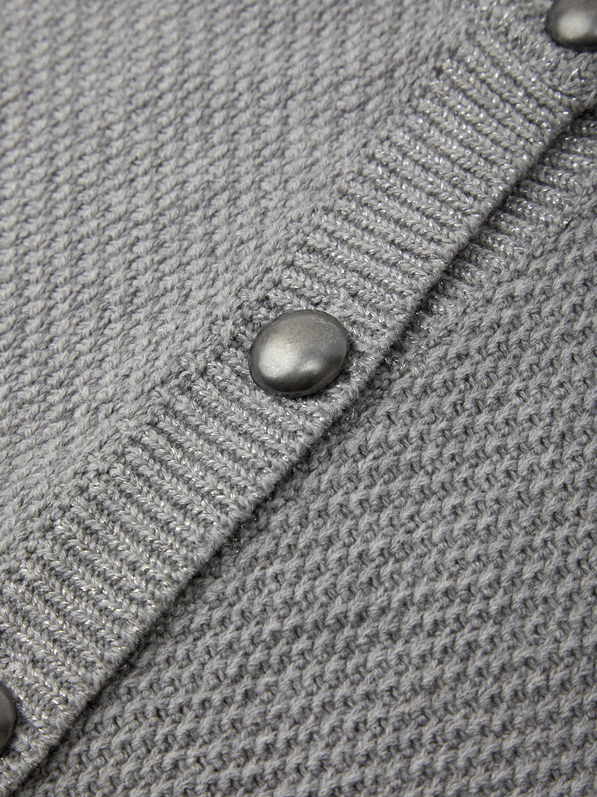 Close-up of a gray textured fabric with a button
