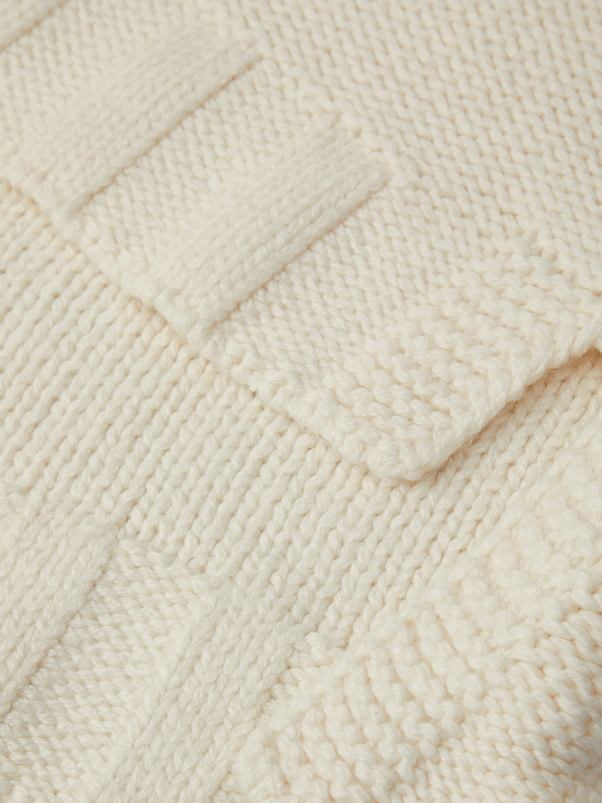 Close-up of a textured beige fabric with a diamond pattern
