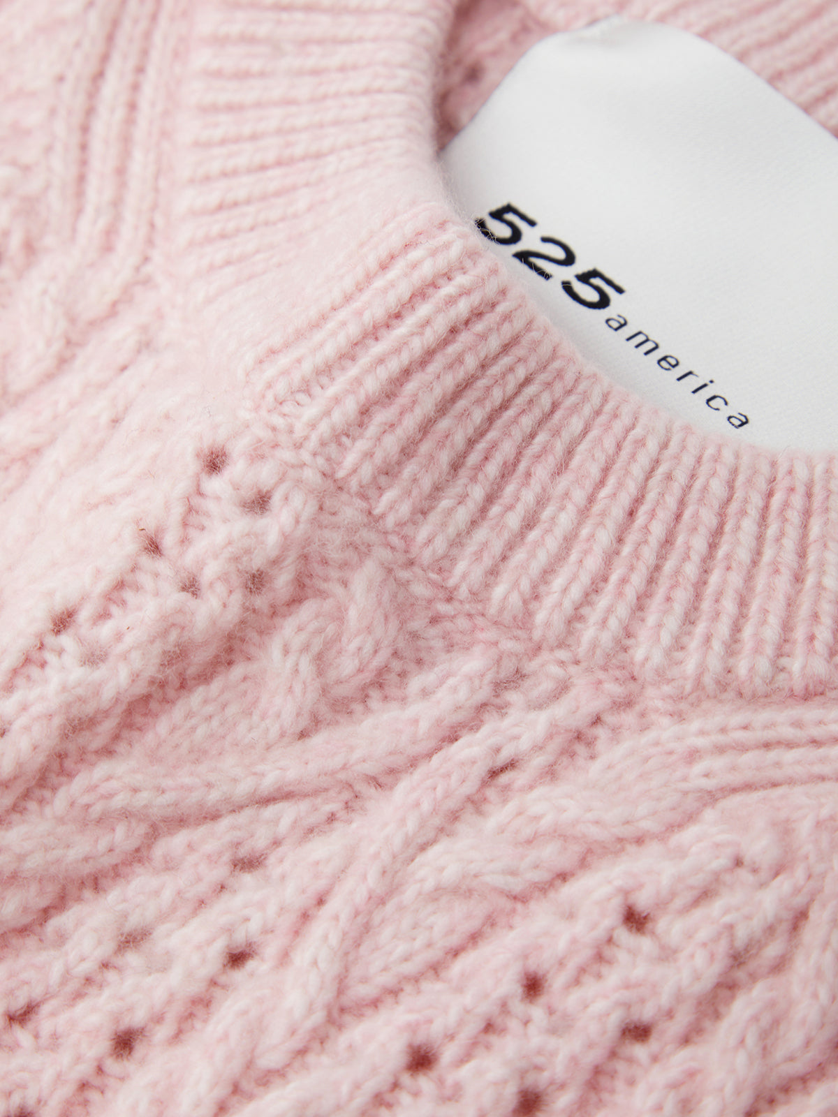 Close-up of pink yarn with a bottle labeled '525 America' on top