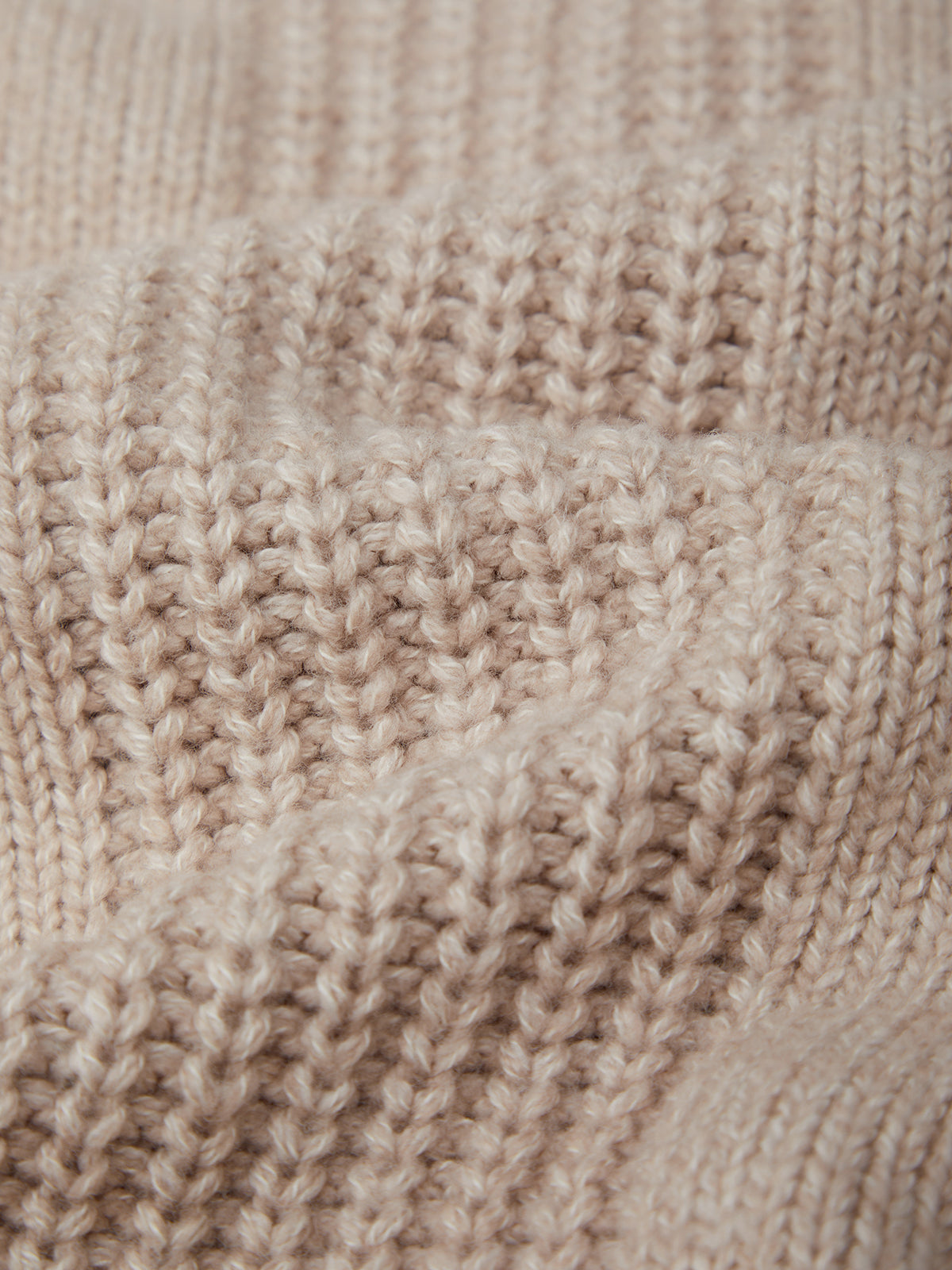Close-up of beige knitted fabric