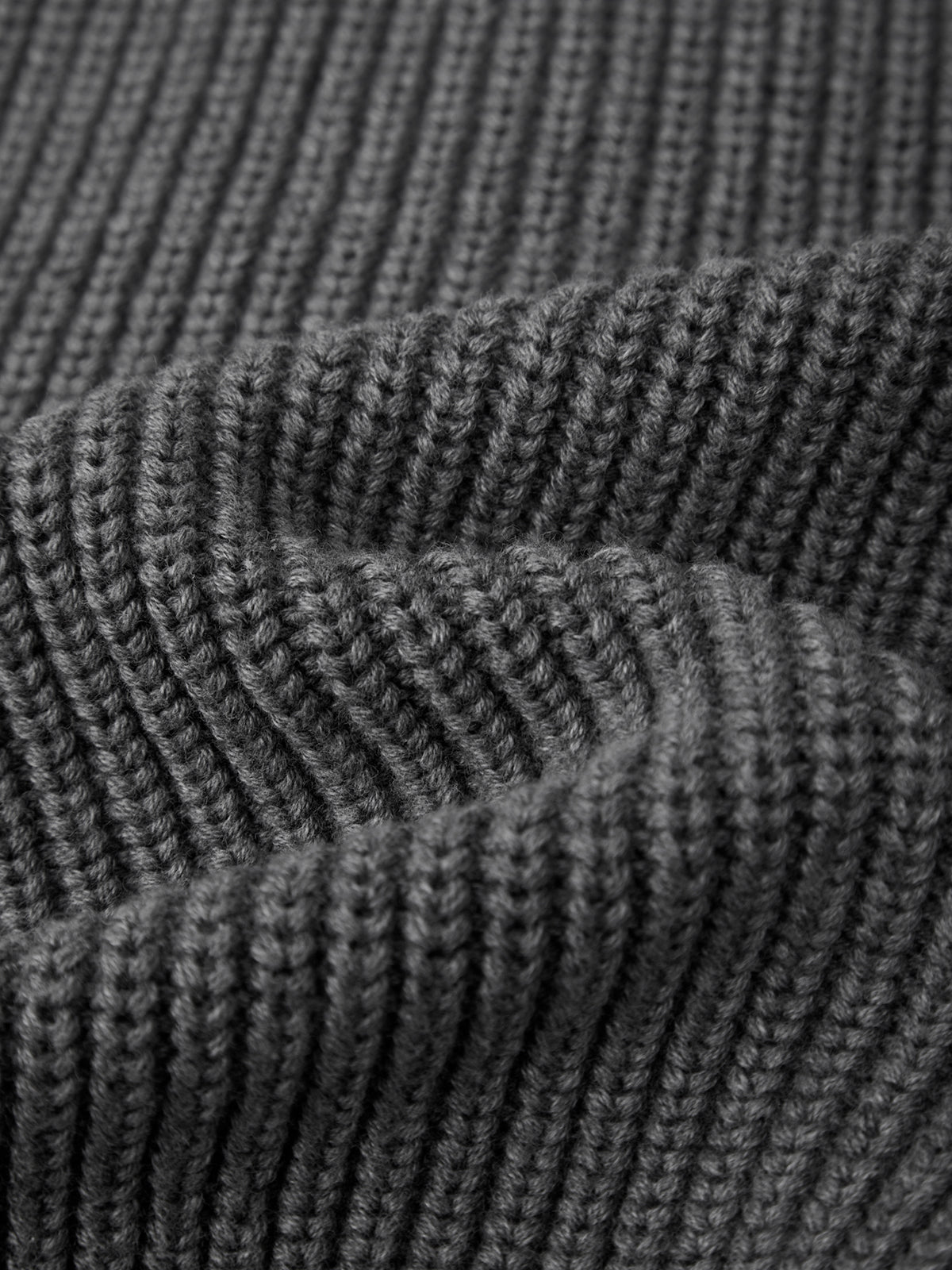Close-up of dark gray knitted fabric texture