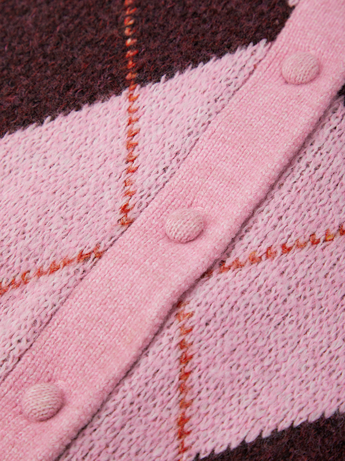 Close-up of a pink and brown striped fabric with button details