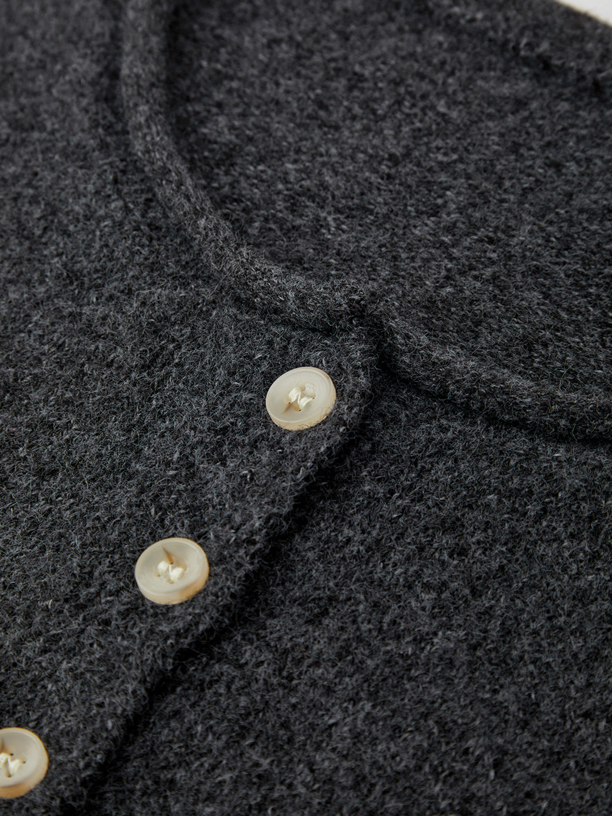 Close-up of a dark gray fabric with buttons on a white background