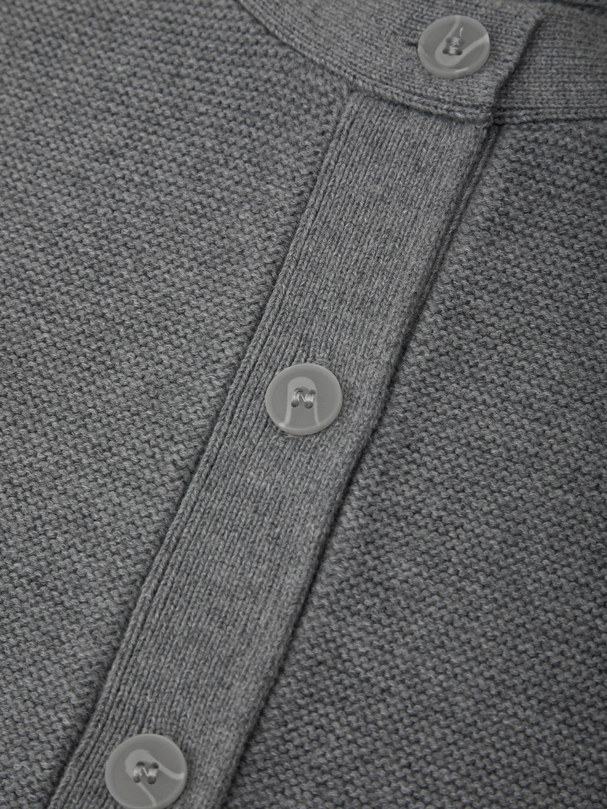 Close-up of a gray textured fabric with buttons