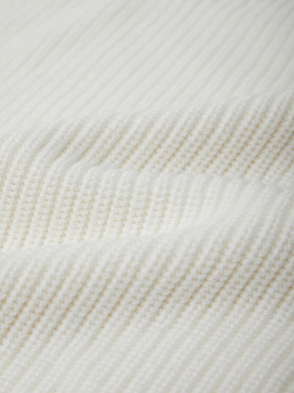 Close-up of a white fabric with a subtle pattern
