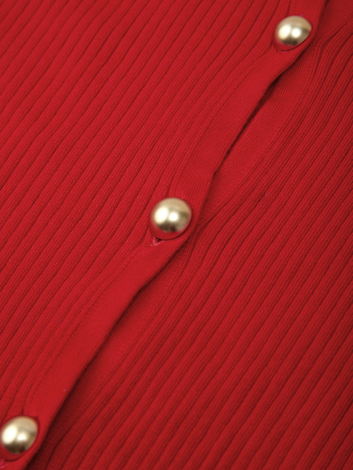Close-up of a red textured fabric with gold buttons.