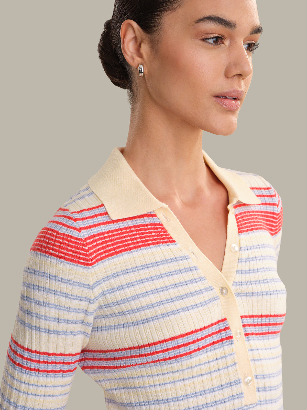 Woman wearing a striped shirt with a neutral background