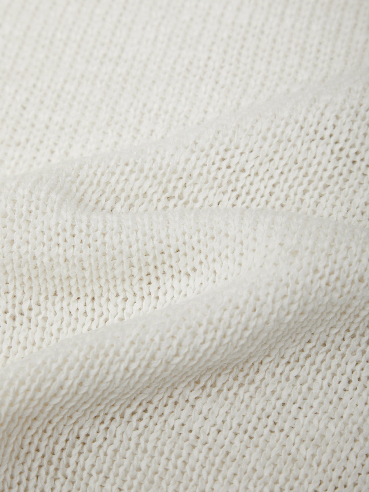 Close-up of a textured white fabric surface