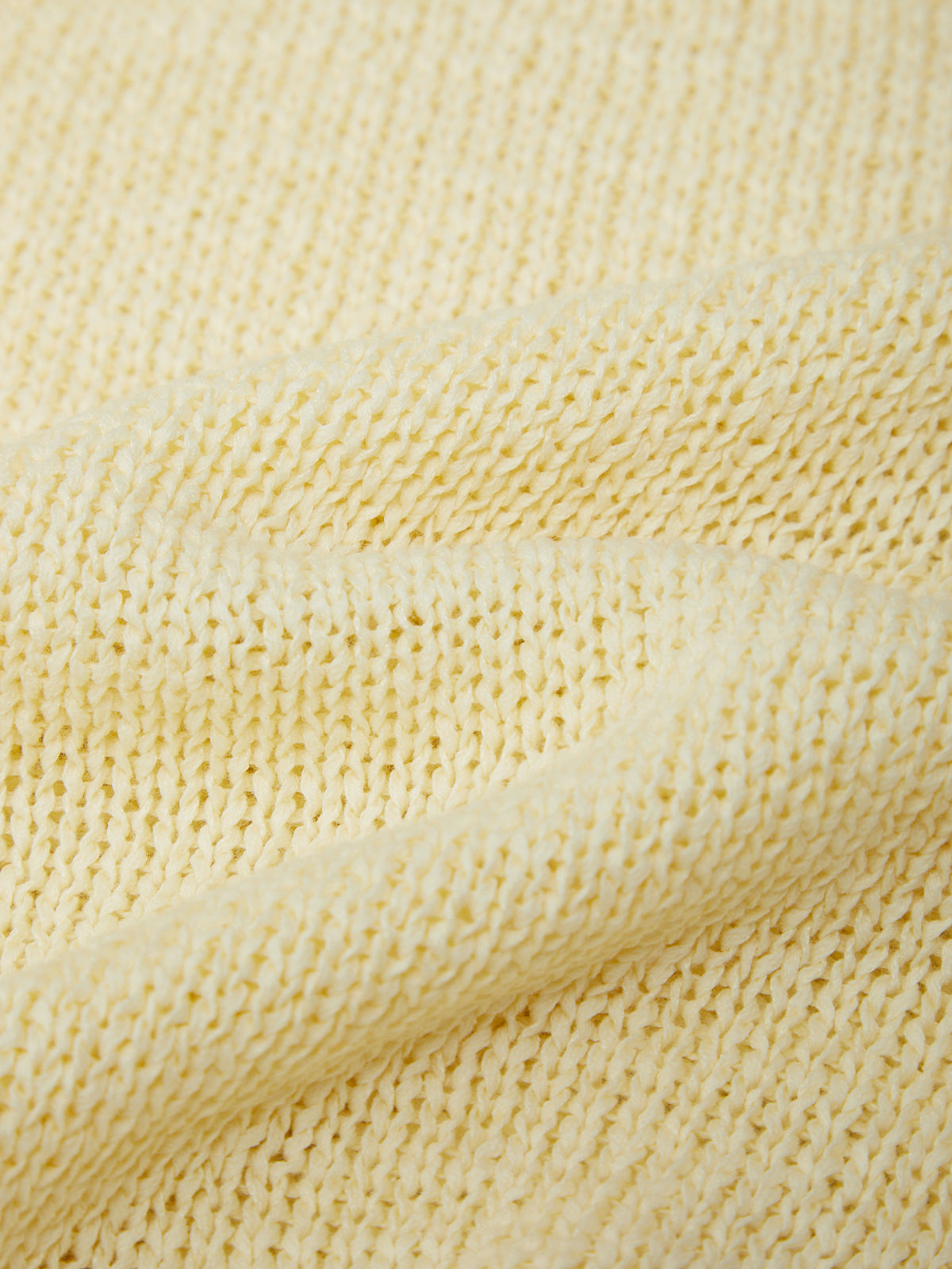 Close-up of a textured yellow fabric surface