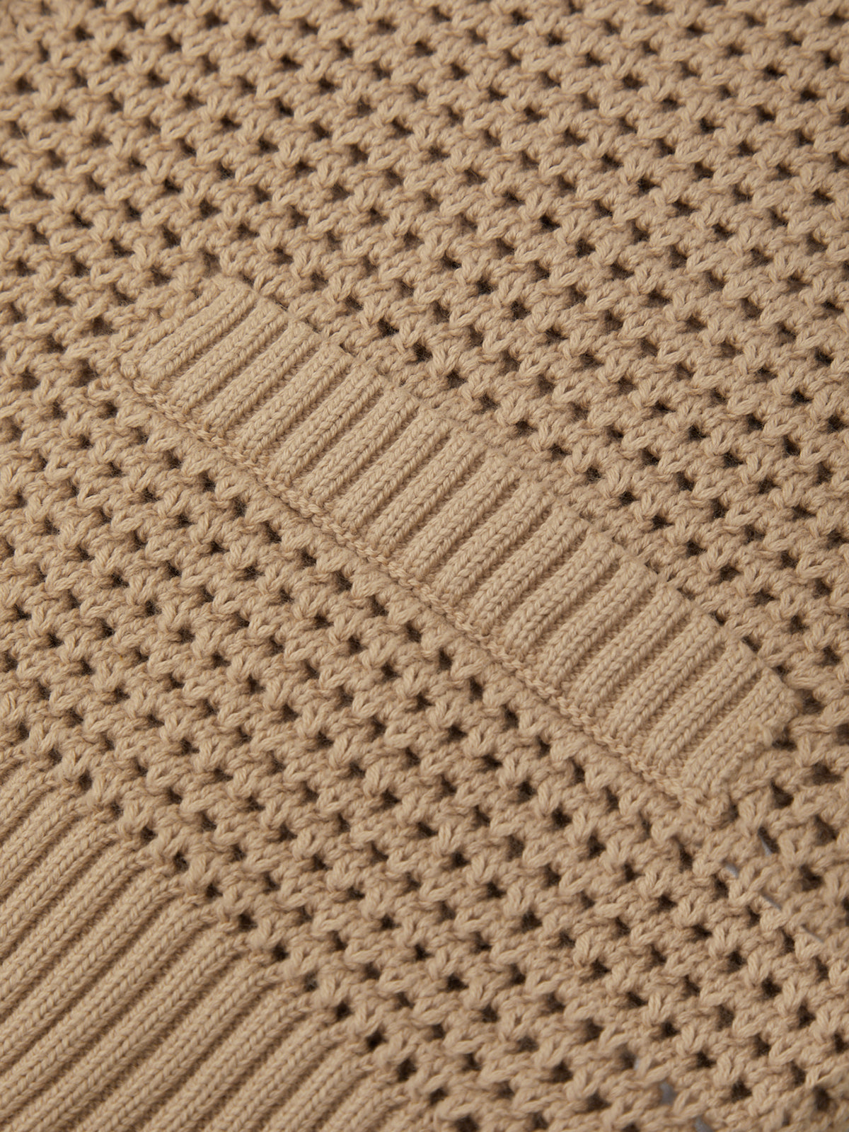 Close-up of a textured brown fabric with a diamond pattern