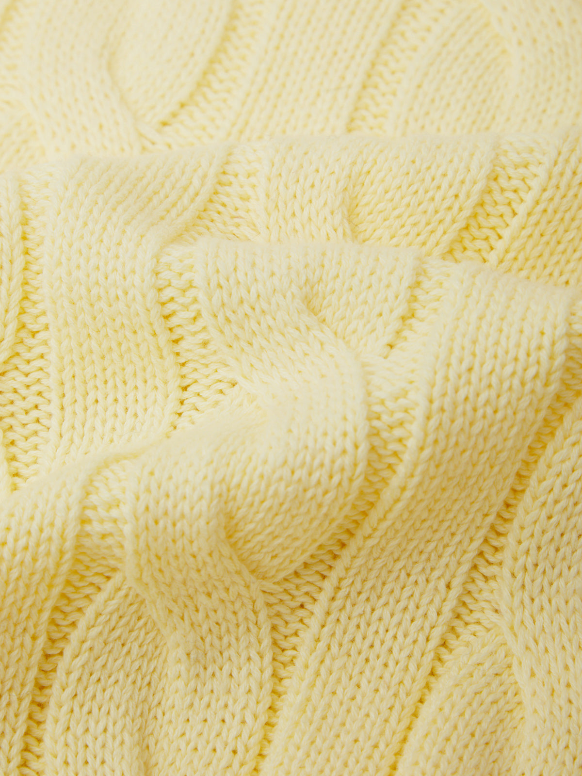 Close-up of a textured yellow fabric with a wavy pattern