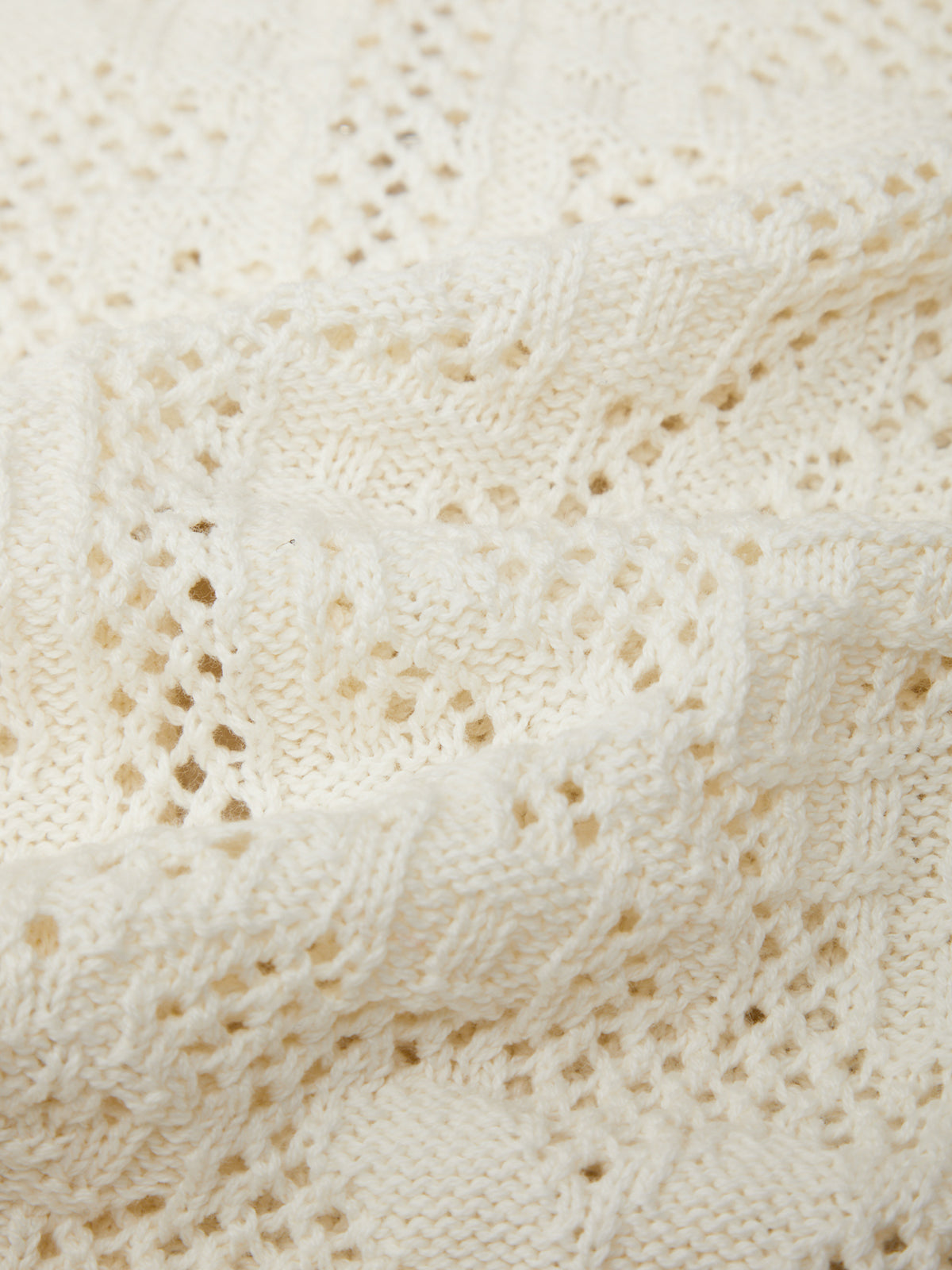 Close-up of a textured white fabric with a subtle pattern