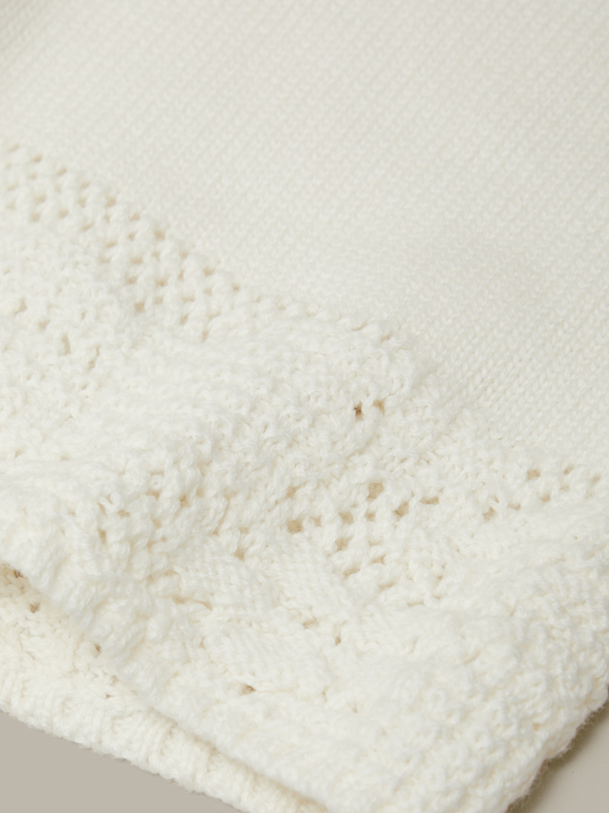 Close-up of a textured white fabric with a subtle pattern
