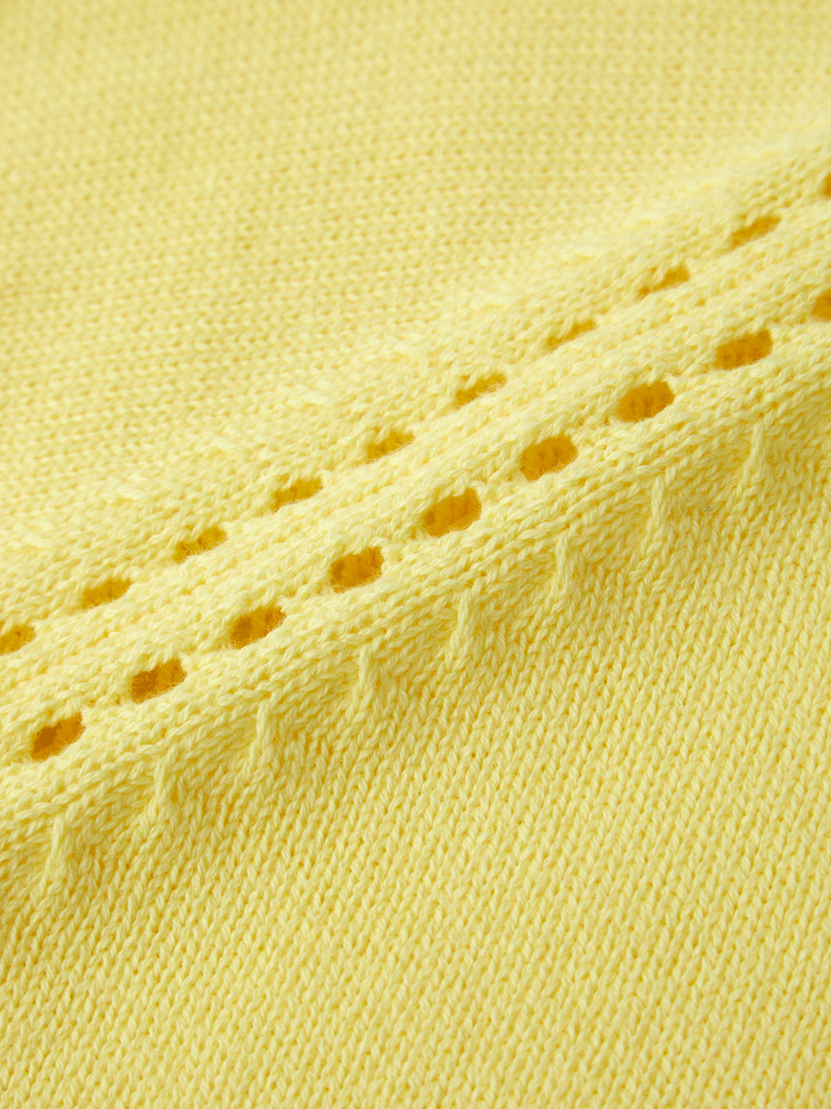 Close-up of yellow fabric with a textured pattern