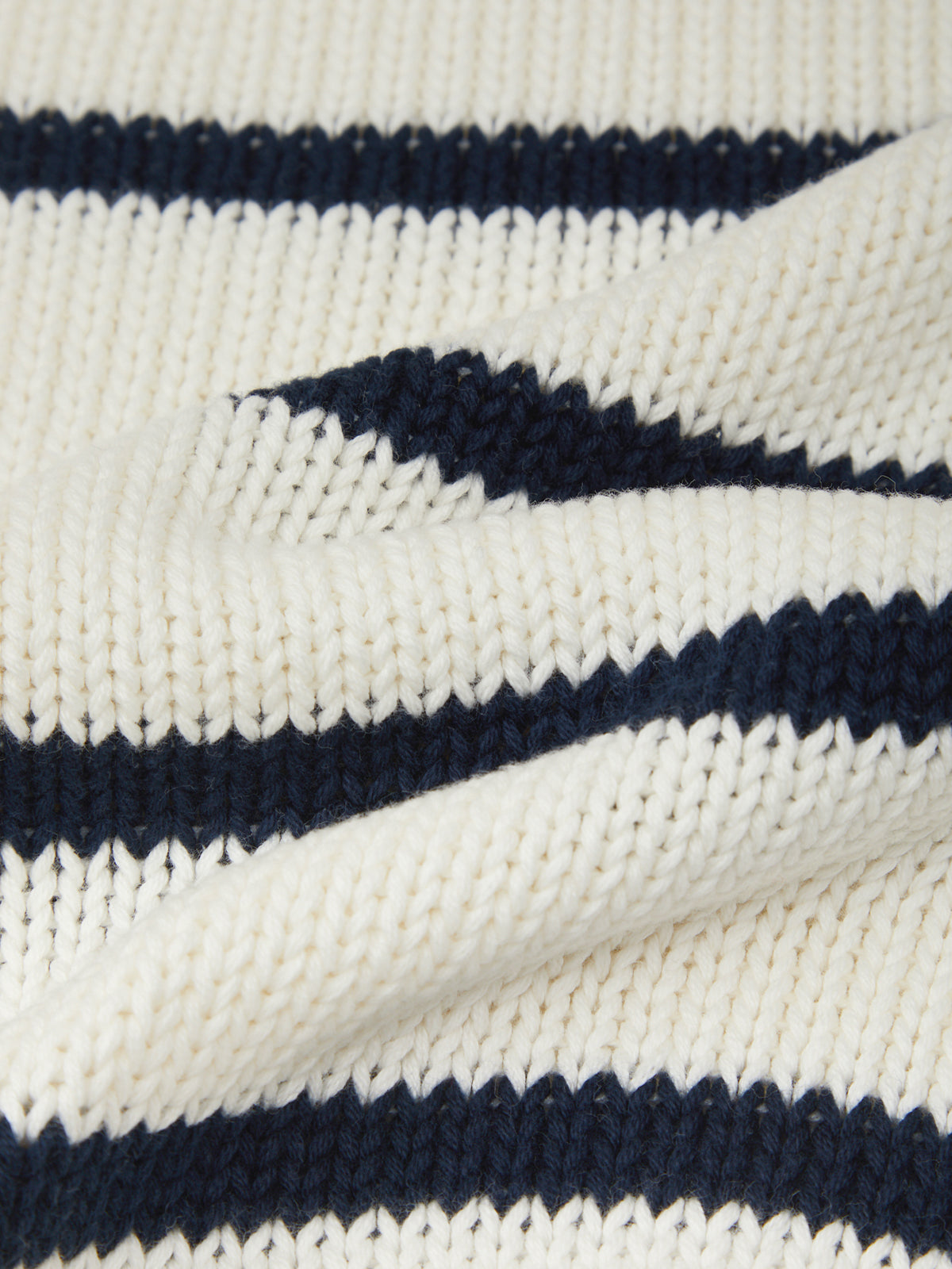 Close-up of a knitted fabric with navy and white stripes