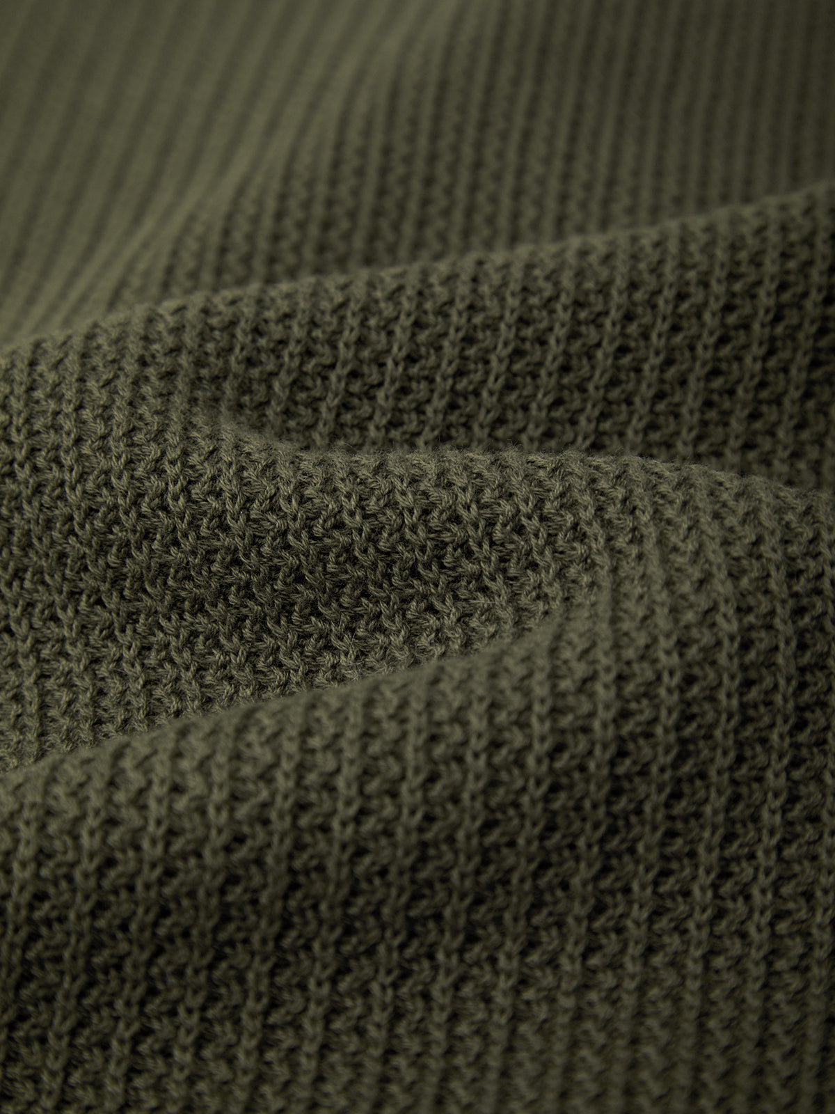 Close-up of a textured green fabric surface