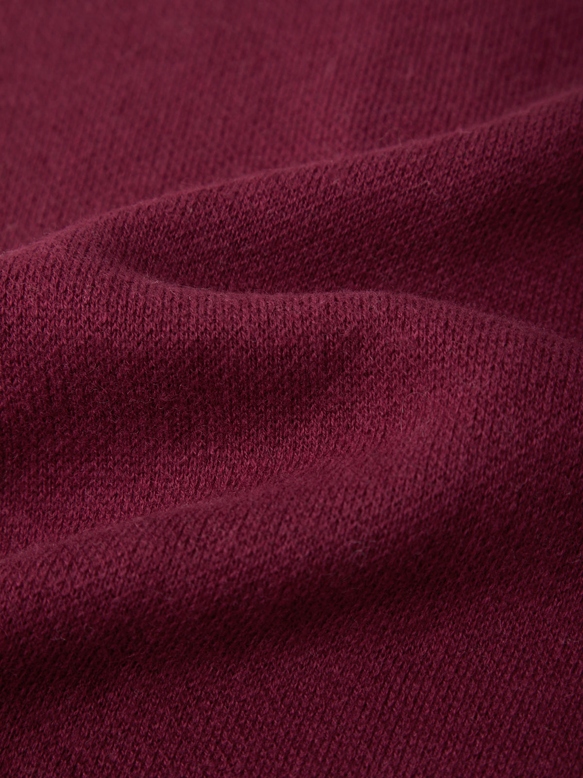 Close-up of maroon fabric with visible texture