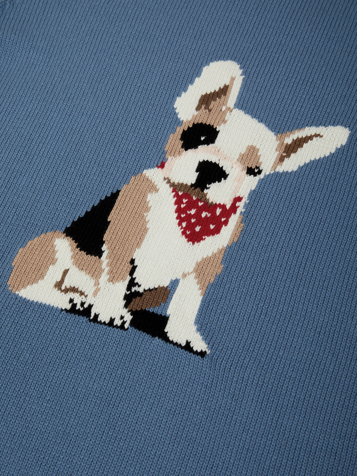 Embroidered dog design on a blue fabric background