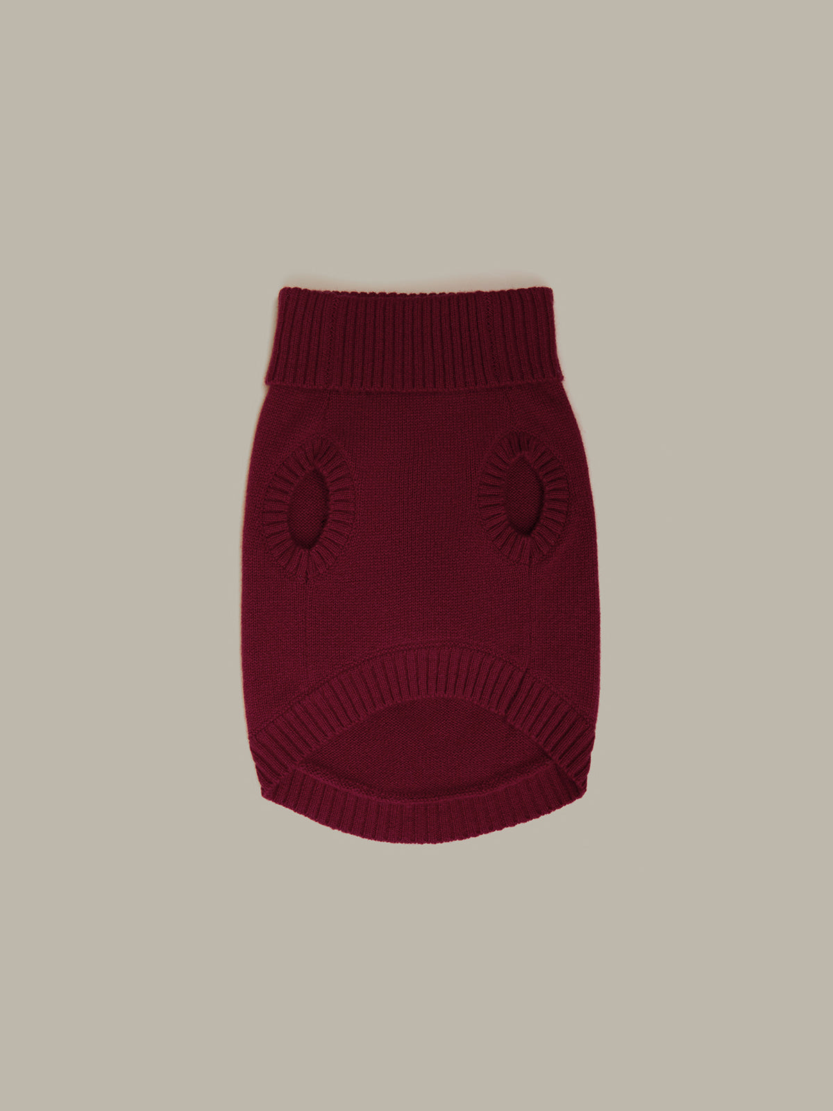Maroon knitted dog sweater on a beige background