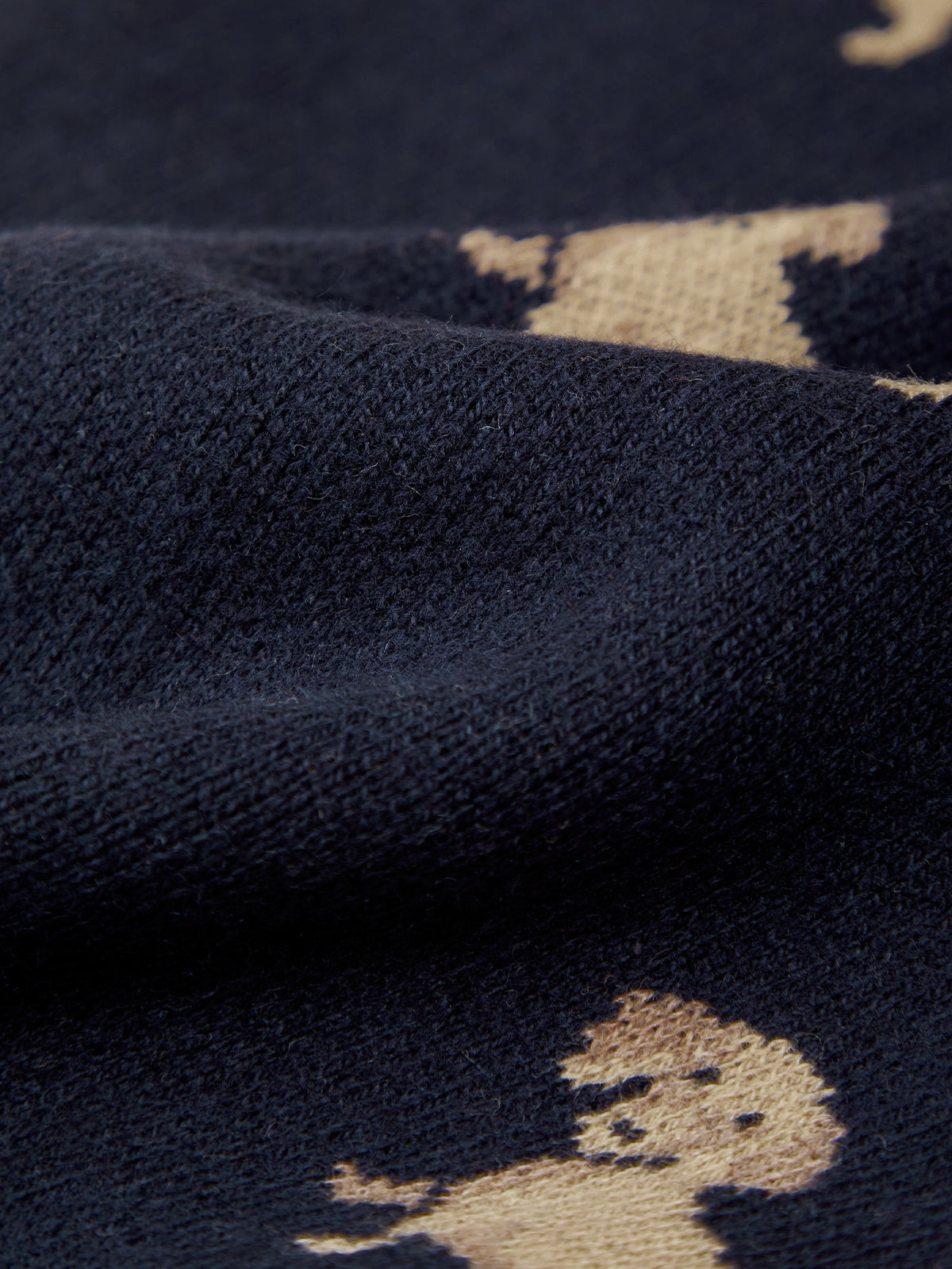 Navy blue fabric with beige embroidered patterns