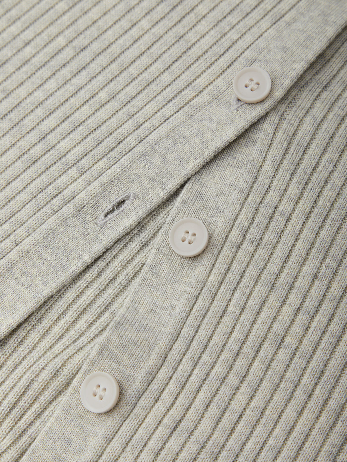 Close-up of a ribbed fabric with buttons on a textured background