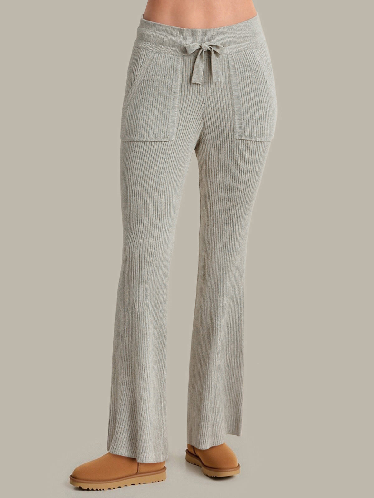 Gray ribbed pants with a tie waist on a neutral background