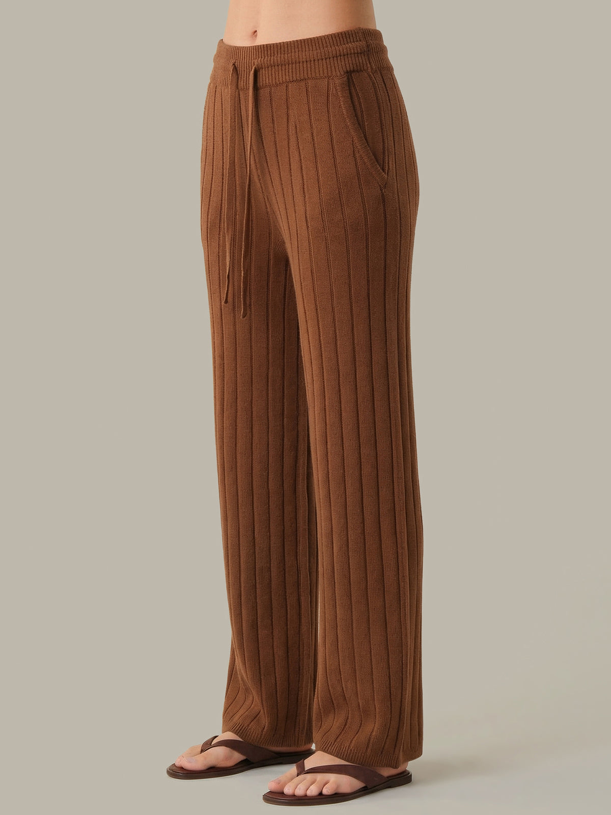 Brown ribbed pants worn by a person on a plain background