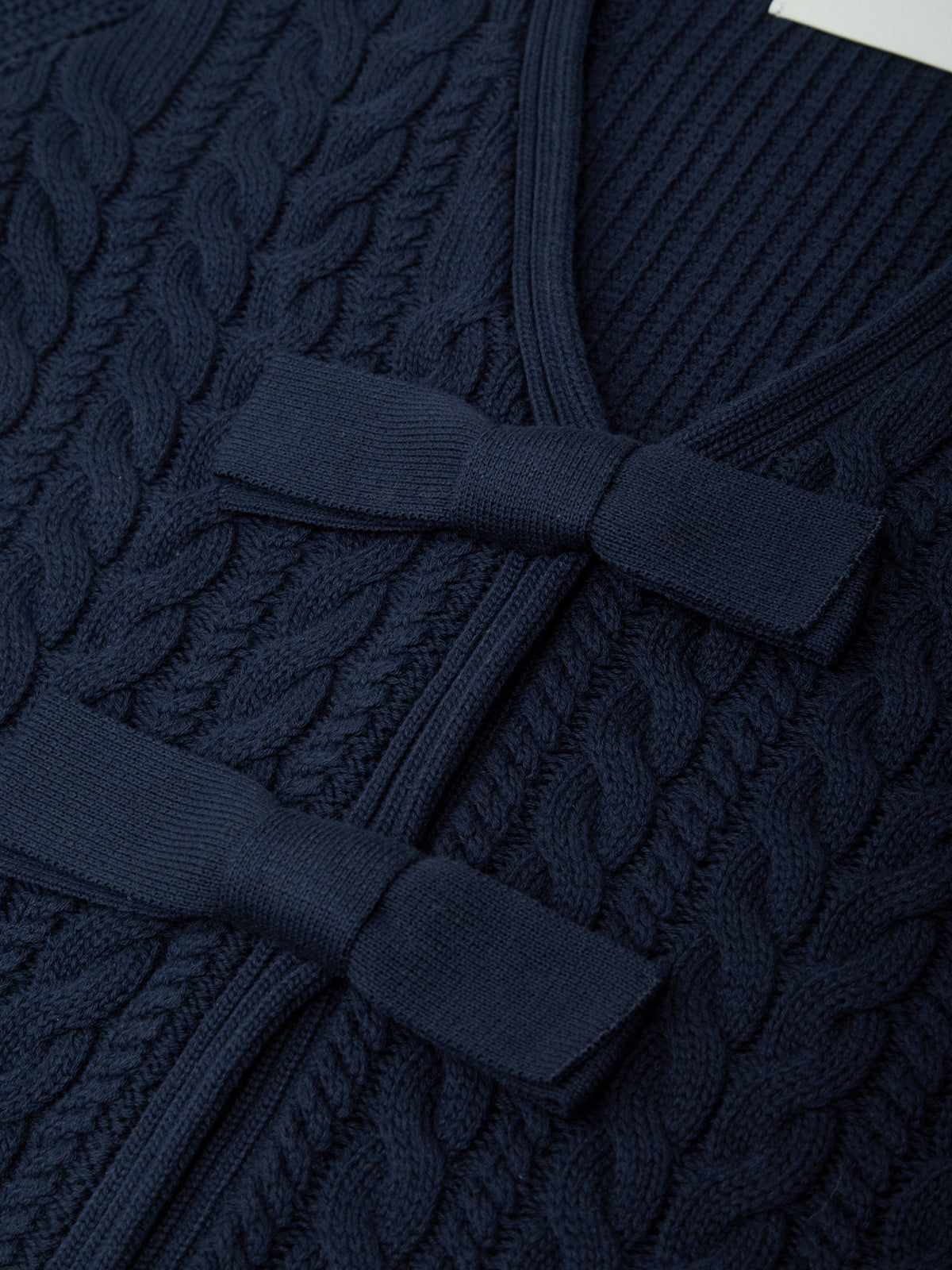 Navy blue textured robe with a belt on a matching background