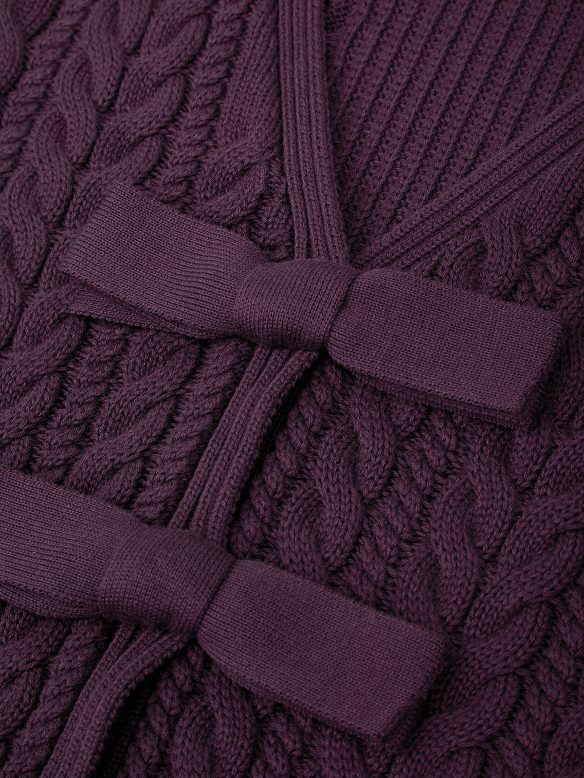 Close-up of a purple knitted garment with a belt