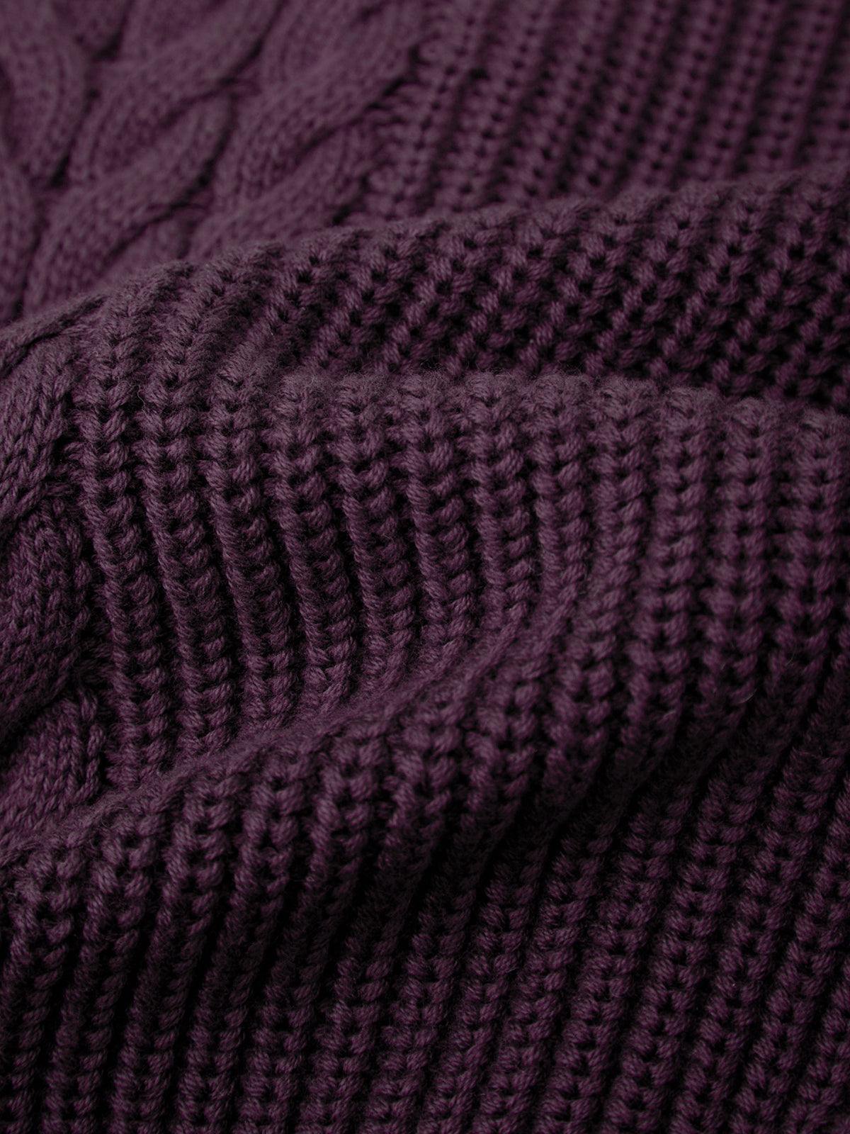 Close-up of a textured purple fabric with a cable knit pattern