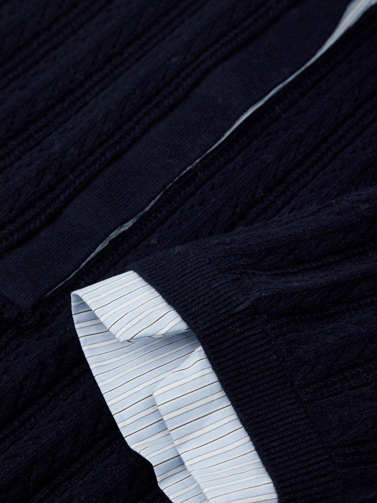 Close-up of a dark blue sweater with light blue lining